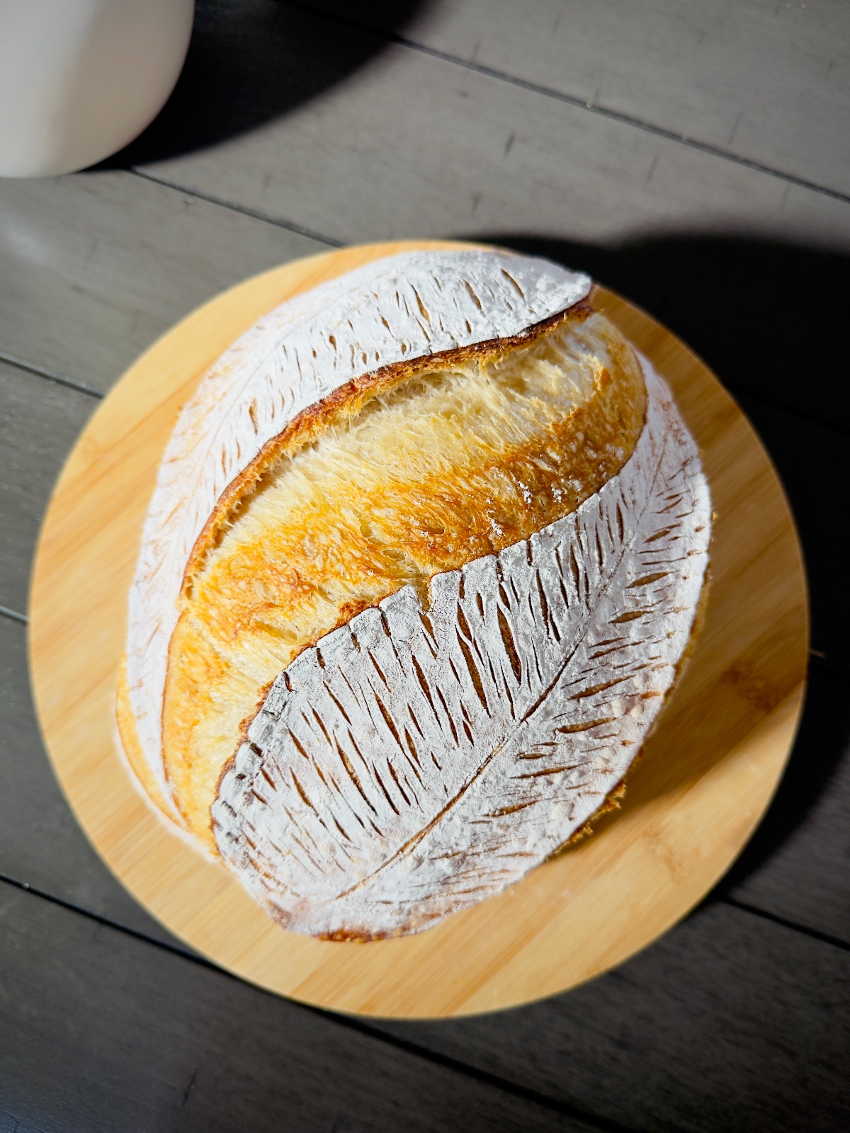 Two sourdough sandwich loaves cooling on a rack in the home kitchen